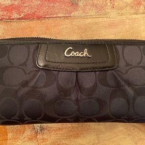 Black full sized Coach wallet.